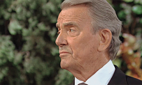 An Older Man In A Suit And Tie Is Looking To The Side GIF