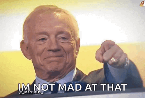 An Older Man In A Suit And Tie Is Pointing At The Camera And Says I 'M Not Mad At That . GIF
