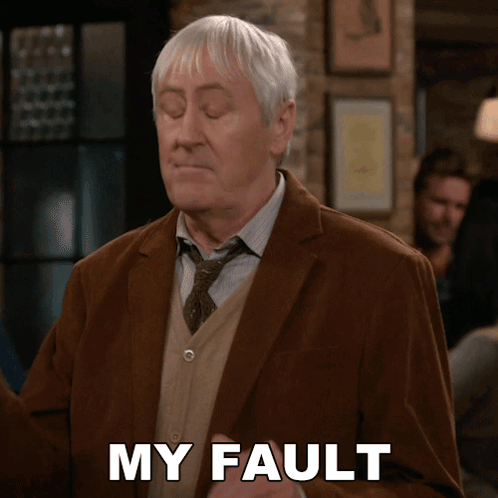 An Older Man In A Suit And Tie Says My Fault GIF