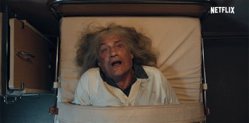 An Older Man Is Laying In A Hospital Bed With A Netflix Logo Behind Him GIF