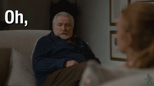 An Older Man Is Sitting In A Chair With The Words Oh Fuck Off Behind Him GIF
