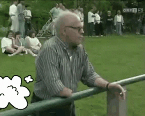 an older man leaning on a railing in a park with a thought bubble with the number 3 on it