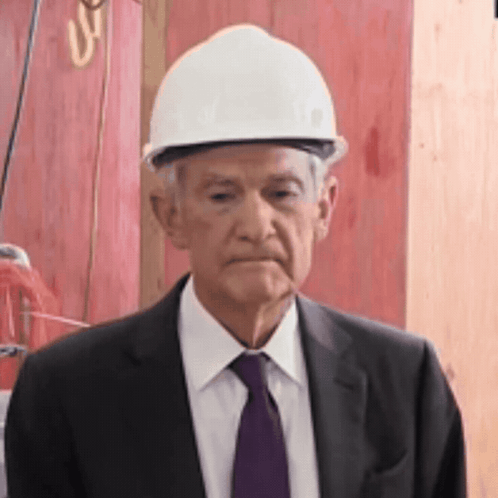 An Older Man Wearing A Hard Hat And Suit GIF