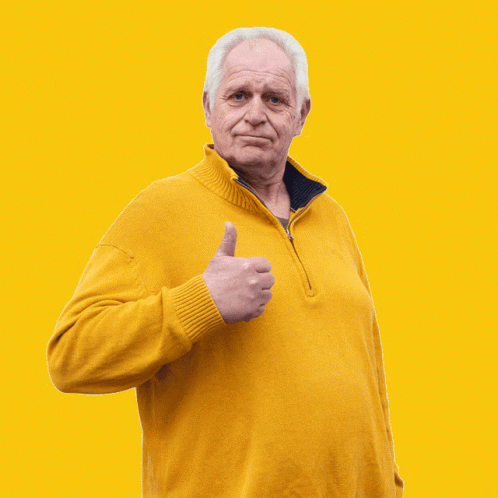 An Older Man Wearing A Yellow Sweater Gives A Thumbs Up GIF