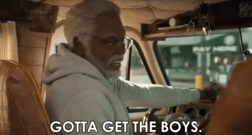 an older man with a beard is driving a van and saying `` gotta get the boys '' .