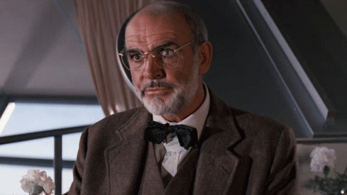 An Older Man With Glasses And A Bow Tie GIF