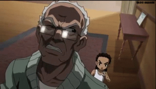 An Older Man With Glasses Is Standing Next To A Younger Man In A Room With A Table . GIF
