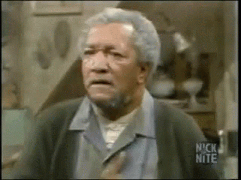An Older Man With Gray Hair And A Beard Is Making A Funny Face In A Room . GIF