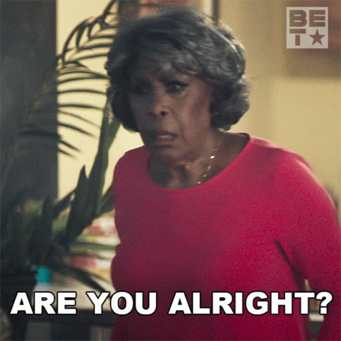 An Older Woman In A Red Shirt Is Asking Are You Alright GIF