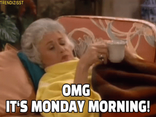 An Older Woman Is Laying On A Couch Holding A Cup Of Coffee And Saying Omg It 'S Monday Morning GIF
