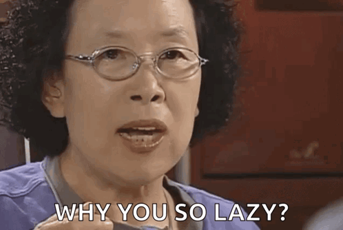 An Older Woman Wearing Glasses Is Asking Why You So Lazy ? GIF