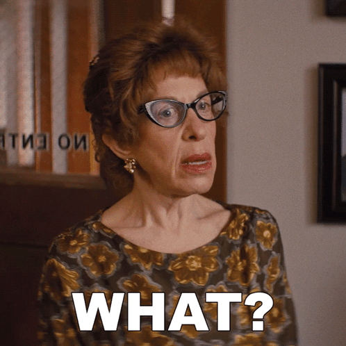 An Older Woman Wearing Glasses Says What GIF