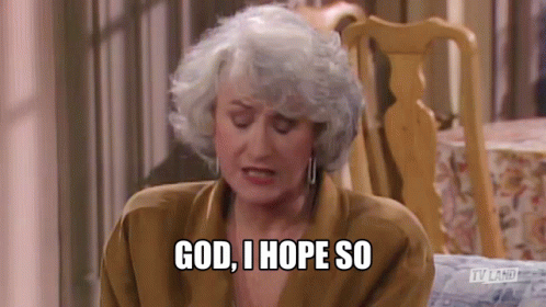 An Older Woman With Gray Hair Is Sitting In A Chair And Saying `` God , I Hope So '' . GIF