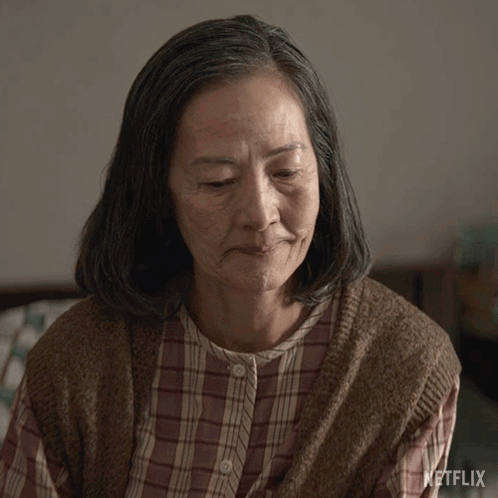 Older Woman With Closed Eyes And Netflix Logo GIF