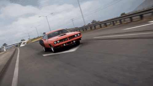 An Orange Car Is Driving Down A Highway With A White Arrow Pointing To The Left GIF