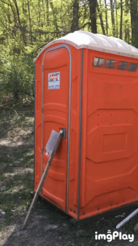 An Orange Portable Toilet With A Sticker On It That Says Imgplay GIF