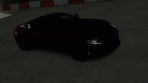 An Orange Sports Car With A Black Top Is Driving Down A Road GIF