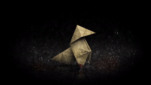 An Origami Bird With A Bloody Beak Is Sitting On A Dark Surface GIF