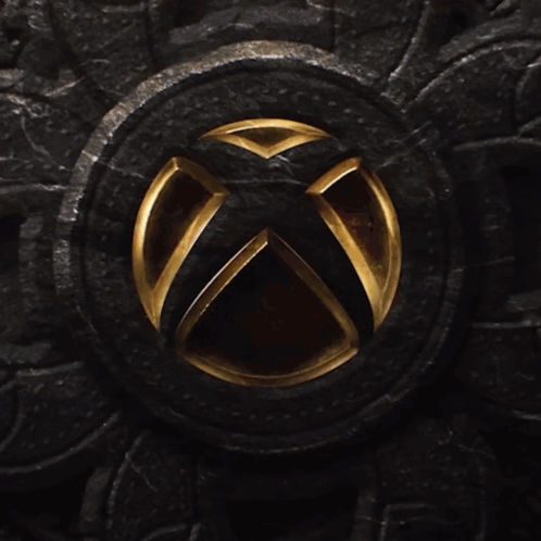 An Xbox Logo Is Lit Up On A Dark Surface GIF