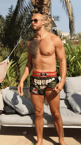 Andrew Tate Flexing His Muscles GIF