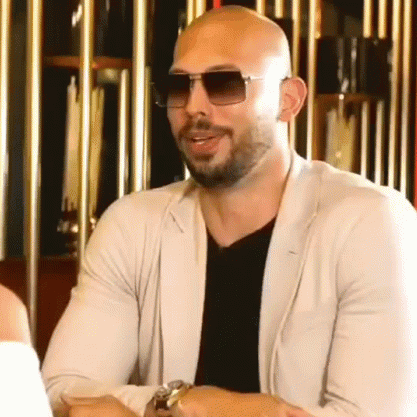 Andrew Tate Laughing Then Sudden Serious Reaction GIF