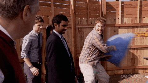 Andy Dwyer Hitting A Man With Stuffed Sack GIF