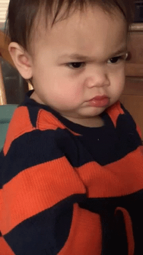 Angry Baby In Orange And Black Striped Shirt GIF