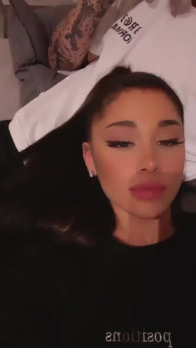 Ariana Grande in Black Sweater Saying Boutique