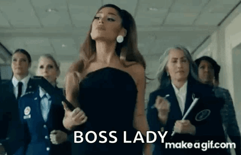Ariana Grande Is Wearing A Black Dress And Standing In A Hallway With Other Women . GIF