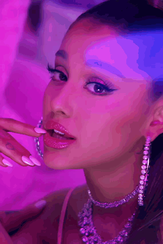 Ariana Grande Is Wearing A Necklace And Hoop Earrings GIF
