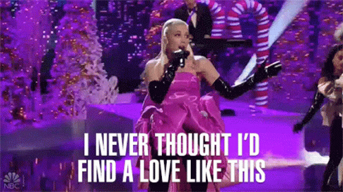 Ariana Grande Singing Into Microphone In Pink Dress And Gloves GIF