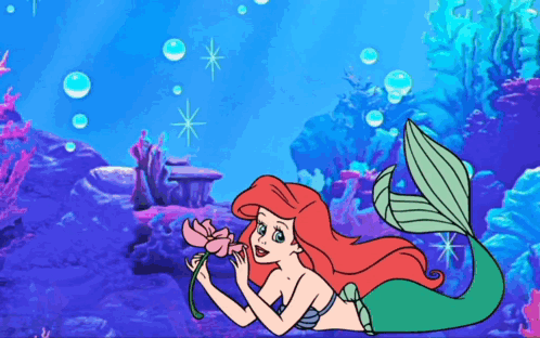 Ariel From The Little Mermaid Is Holding A Pink Flower GIF