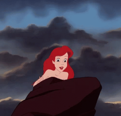 Ariel From The Little Mermaid Is Sitting On A Rock Looking At The Sky . GIF