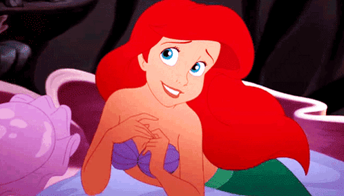 Ariel From The Little Mermaid Is Smiling And Looking At The Camera GIF