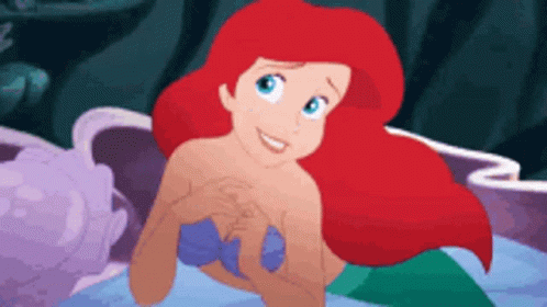 Ariel From The Little Mermaid Is Smiling While Swimming In The Ocean GIF
