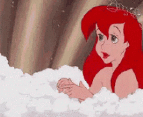 Ariel From The Little Mermaid Is Taking A Bath In A Bathtub Filled With Bubbles . GIF
