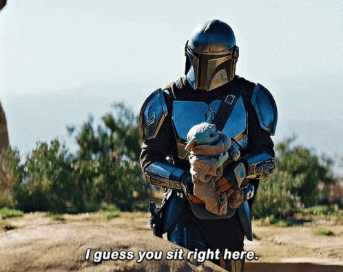 Armored Man Holding Baby Says I Guess You Sit Right Here