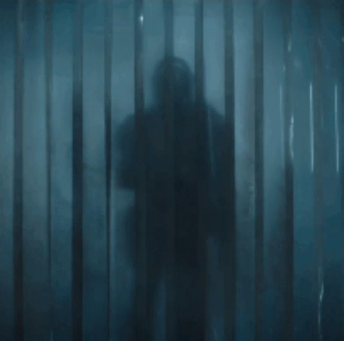 Armored Man Holding Sword in Doorway