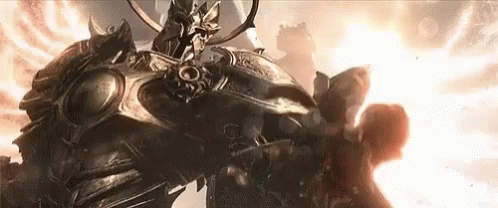 Armored Man Next To Giant Armored Statue GIF