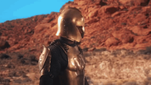 Armored Man With Gold Helmet in Desert