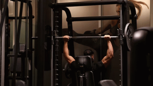 Arnold Schwarzenegger Flexing Muscles Looking At Camera GIF