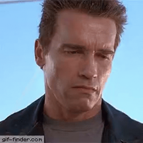 Arnold Schwarzenegger Is Wearing A Denim Jacket And A Black Shirt And Making A Funny Face . GIF