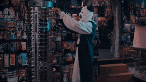 Art The Clown Takes Eyeglass From Display GIF