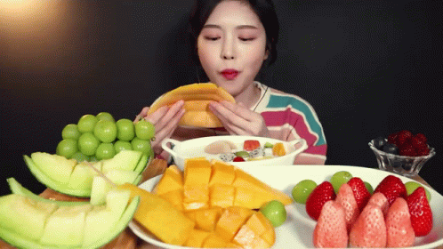 Asian Girl Eating Fruit GIF