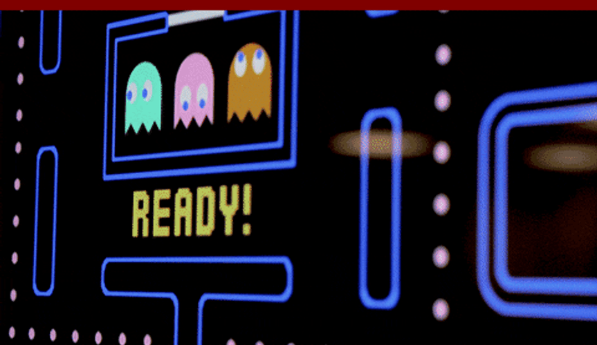 Asian Guy Playing Pac Man On Big Screen GIF