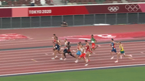 Athletes Running on Track With Tokyo 2020 Banner