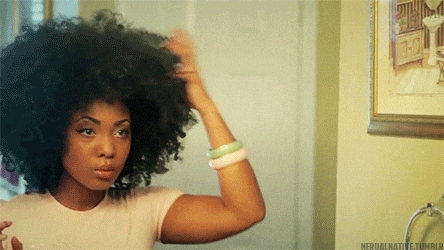 Attractive Black Woman Adjusting Afro Volume GIF