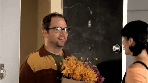Awkward Guy Giving Flowers GIF