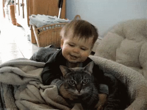 Baby and Cat Looking at Each Other