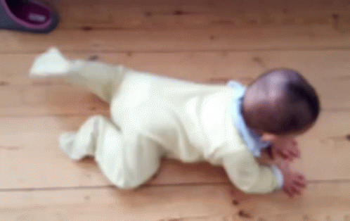 Baby Crawling on Wooden Floor Blurry Photo